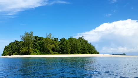 Idyllic-tiny-remote-tropical-island-with-white-sandy-beach,-green-trees-and-blue-ocean-water-in-Bougainville,-Papua-New-Guinea