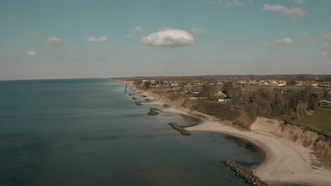 Beach-near-Brenderup-on-a-sunny-day,-seen-from-drone