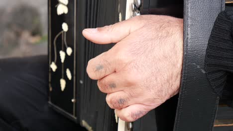 close up of a man playing an accordion