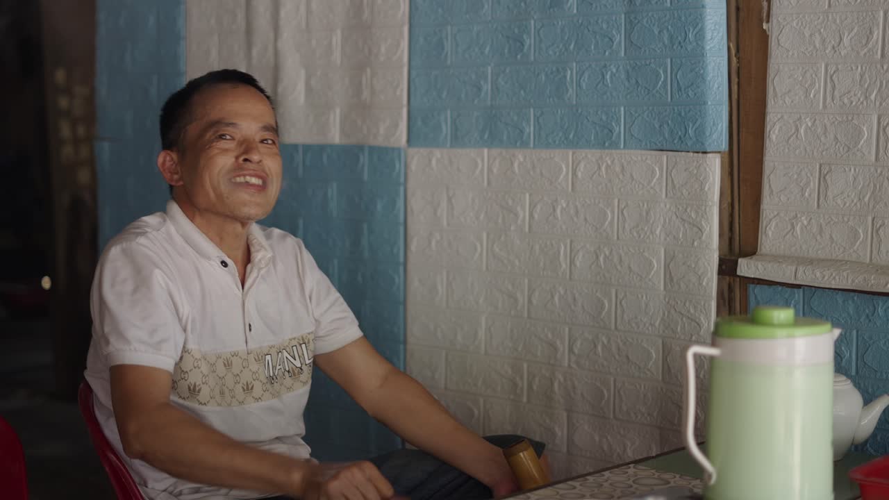 Man Smoking Bamboo Pipe in a Vietnamese Restaurant