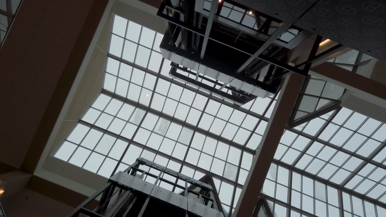 Modern Building Atrium with Glass Ceiling and Elevators