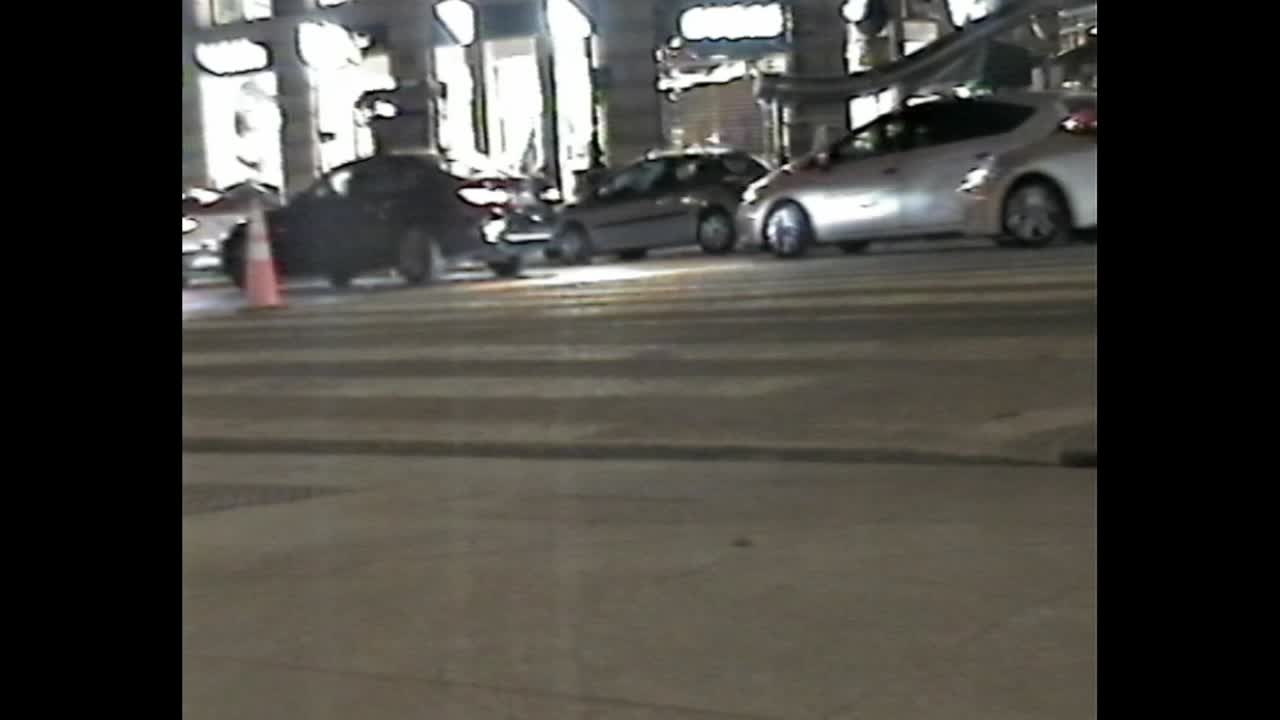 City traffic at night with parked cars