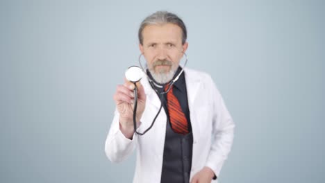 doctor listening to camera with stethoscope.