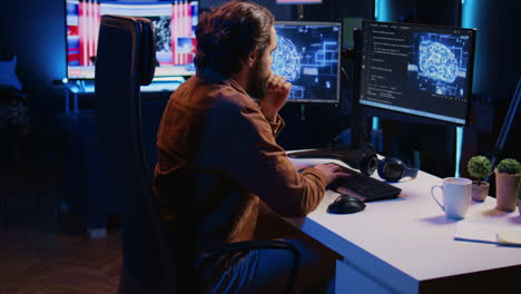 Freelancing programmer writes artificial intelligence code on desktop PC