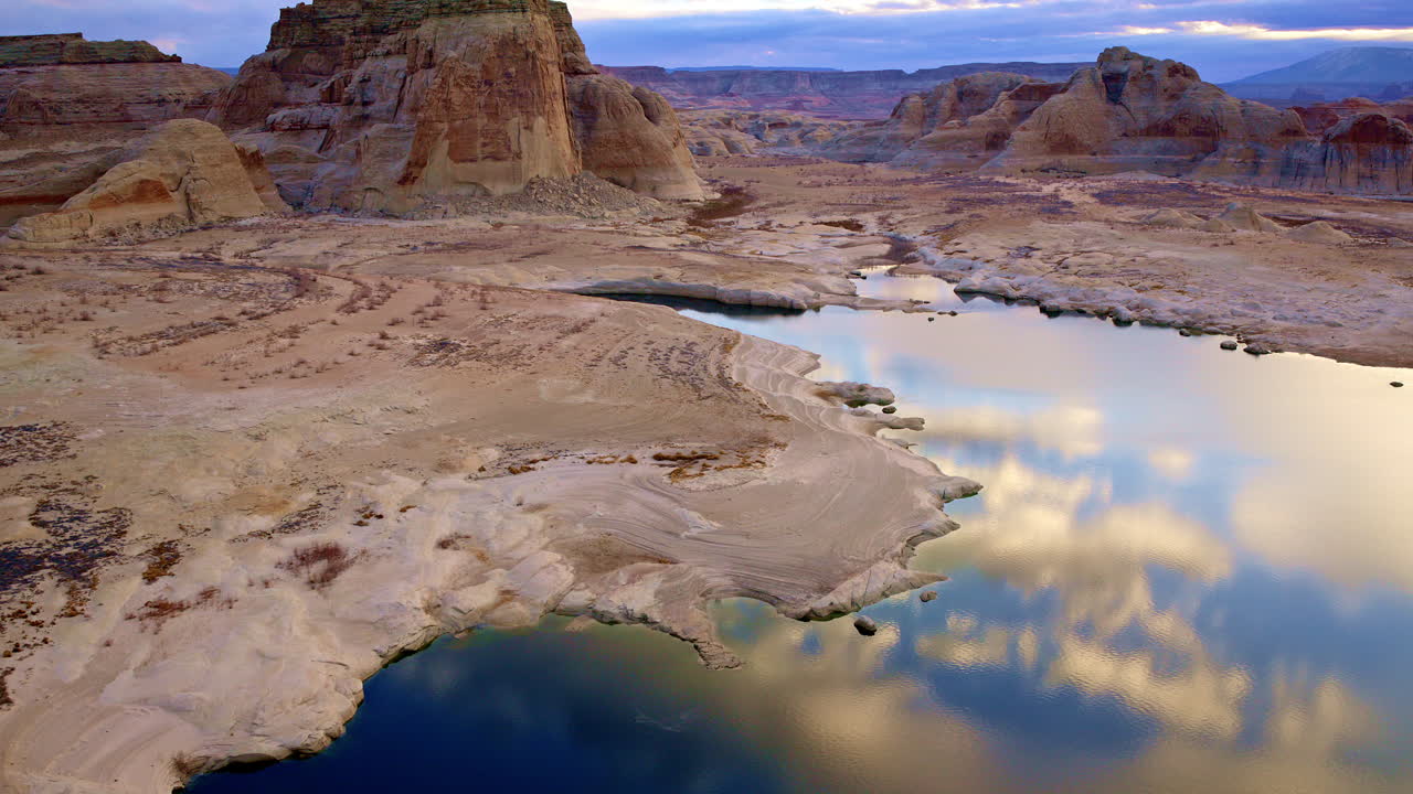 A high-altitude aerial shot showcasing the intricate patterns of the desert and red rocks near Lake Powell.