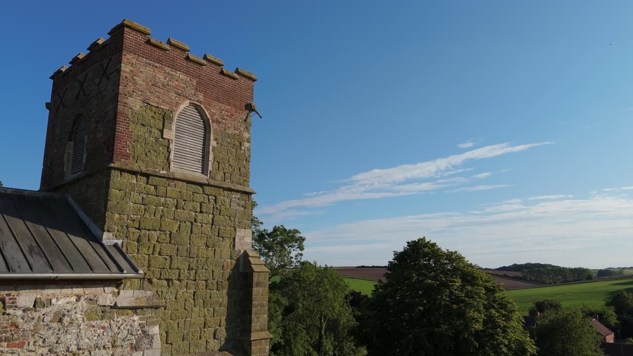 Quaint rural village church is a small, picturesque rural setting. St Mary's Church on the High Street of Burwell a peaceful atmosphere, beautiful natural landscapes, rolling hills. Rooftop views