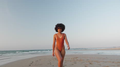 cute mulatto model posing at the beach in a bikini set