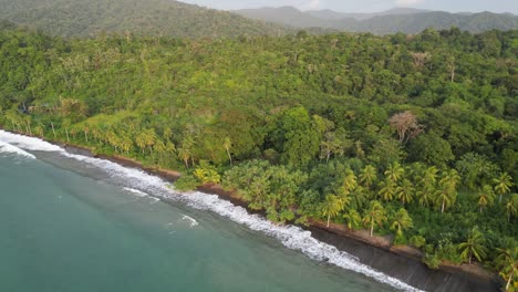 pacific ocean meets the lush jungle of the chocó region at playa mecana on the pacific coast of colombia