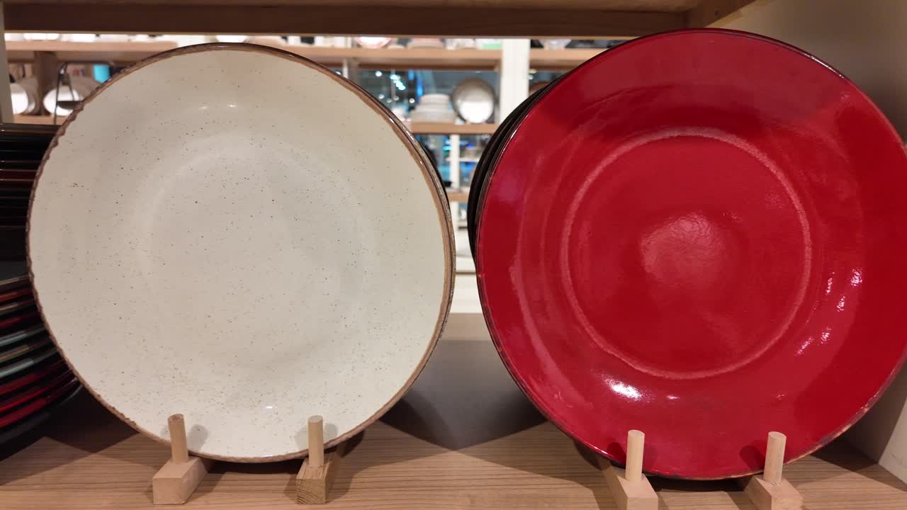 Red and White Oval Plates on Wooden Shelf