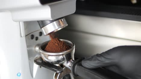 Coffee-Grounds-Coming-Out-Coffee-Grinder-Into-Group-Head-Close-Up