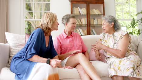 senior diverse group of women share a conversation at home