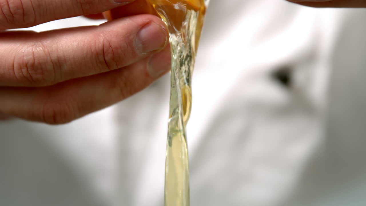 Chef in white cracking an egg