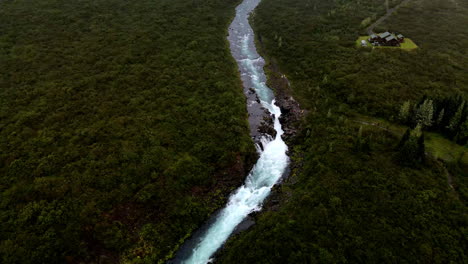 Río-Con-Una-Cascada-Rodeada-De-árboles-Y-Vegetación-En-Islandia