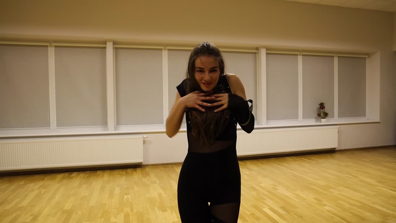 Skilled female dancer recreating an intense modern choreography with passion in an empty studio