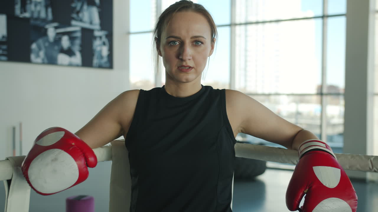 Woman resting in boxing ring