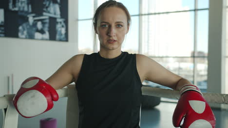woman resting in boxing ring