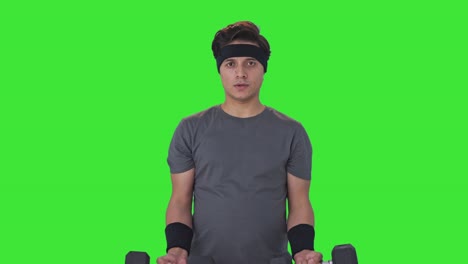 indian man lifting heavy dumbells and doing exercise green screen