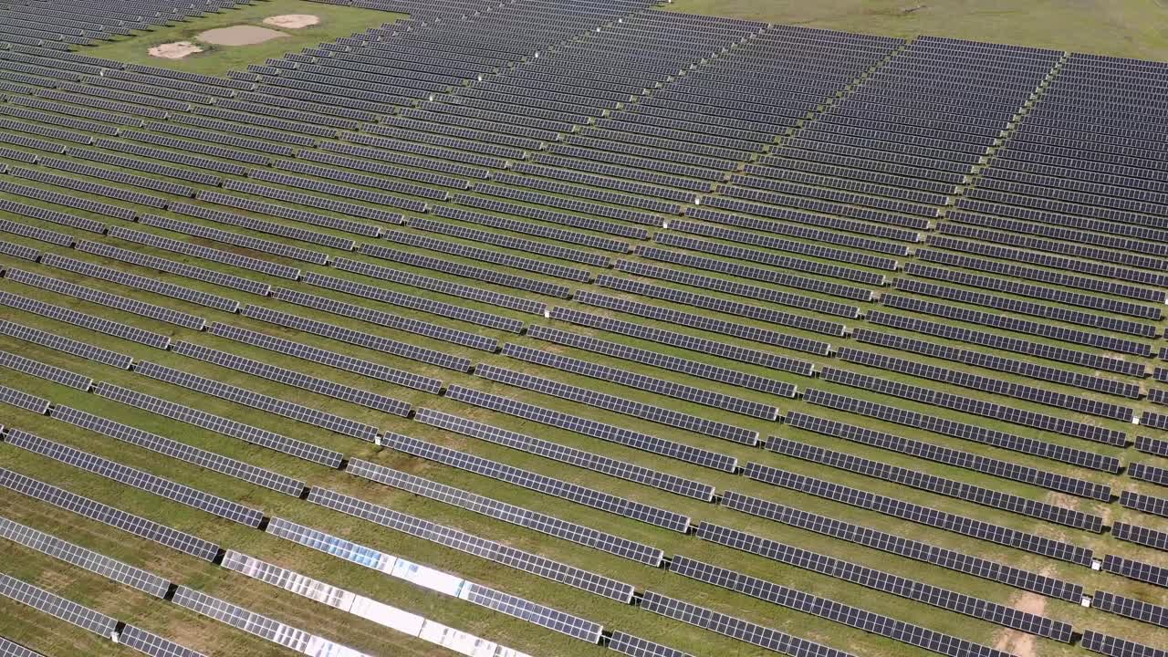 4K drone footage of an Australian solar farm, showcasing rows of solar panels harnessing clean energy.