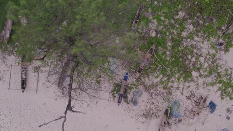 Top-down-of-traditional-wooden-fishing-boats-at-Pantai-Mandorak,-aerial