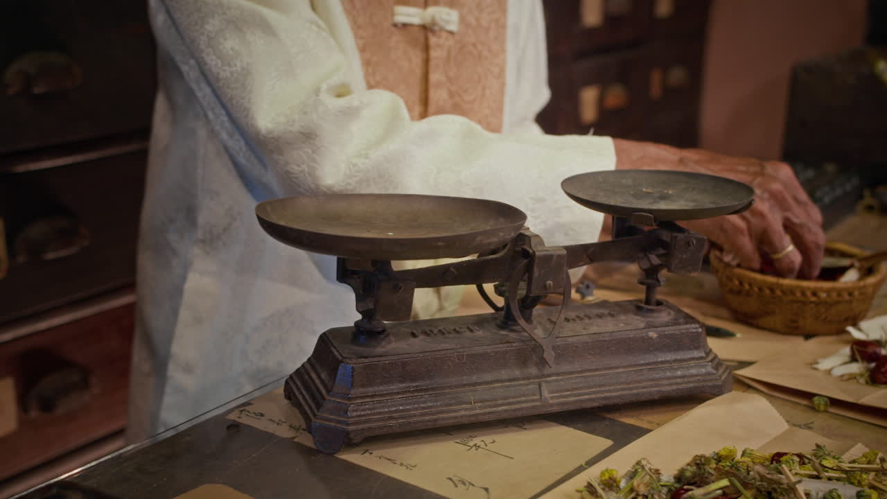 Male Healer Weighing Herbs to make Recipe at Pharmacy