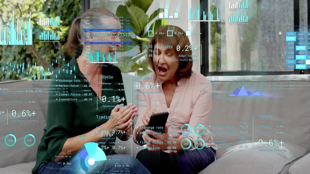 Two women on gray sofa tapping phone and activating financial HUD, reviewing finances, smiling