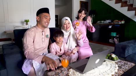 muslim family celebrating eid al-fitr and video calling relative in distant