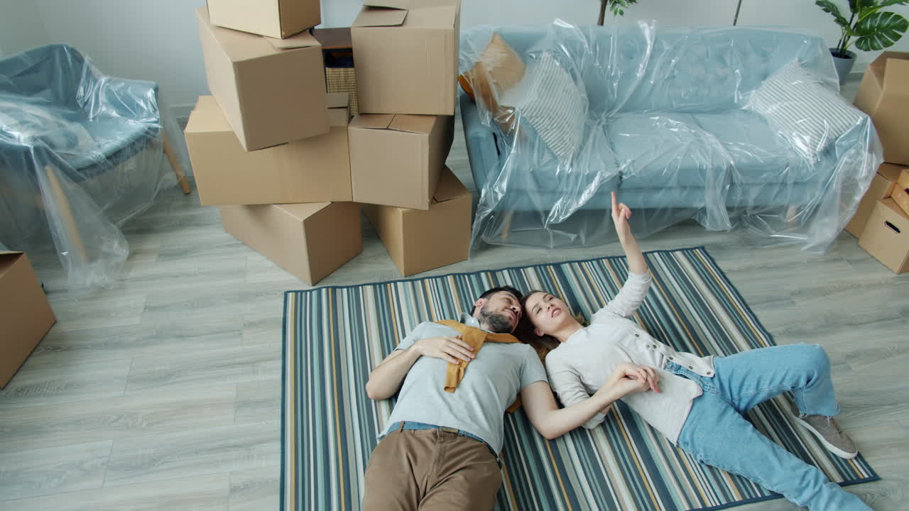 Couple Relaxing on Carpet During House Moving