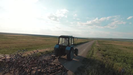 farmer driving tractor in a field