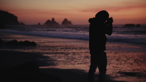 silhouette of photographer at sunset beach