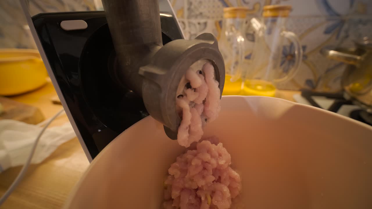 Close-up of Electric Meat Grinder Making Minced Meat in a Kitchen