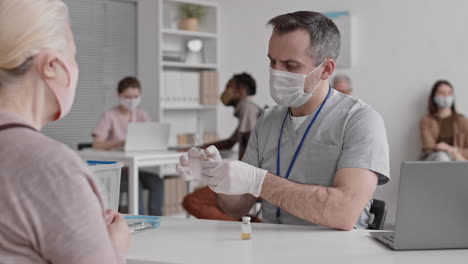 doctor talking to patient before vaccination