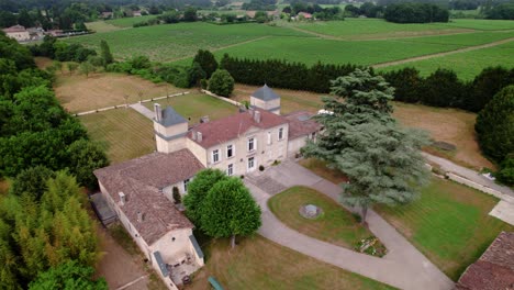 aerial establishing shot of a luxury villa in the bordeaux countryside