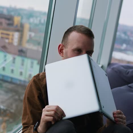 young man sitting on a floor with laptop computer. work stress concept of man