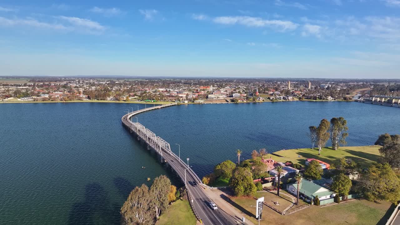 Aerial rise up over the road bridge with the town of Yarrawonga Victoria Australia beyond