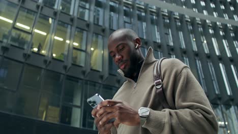 man using smartphone outdoors in a city