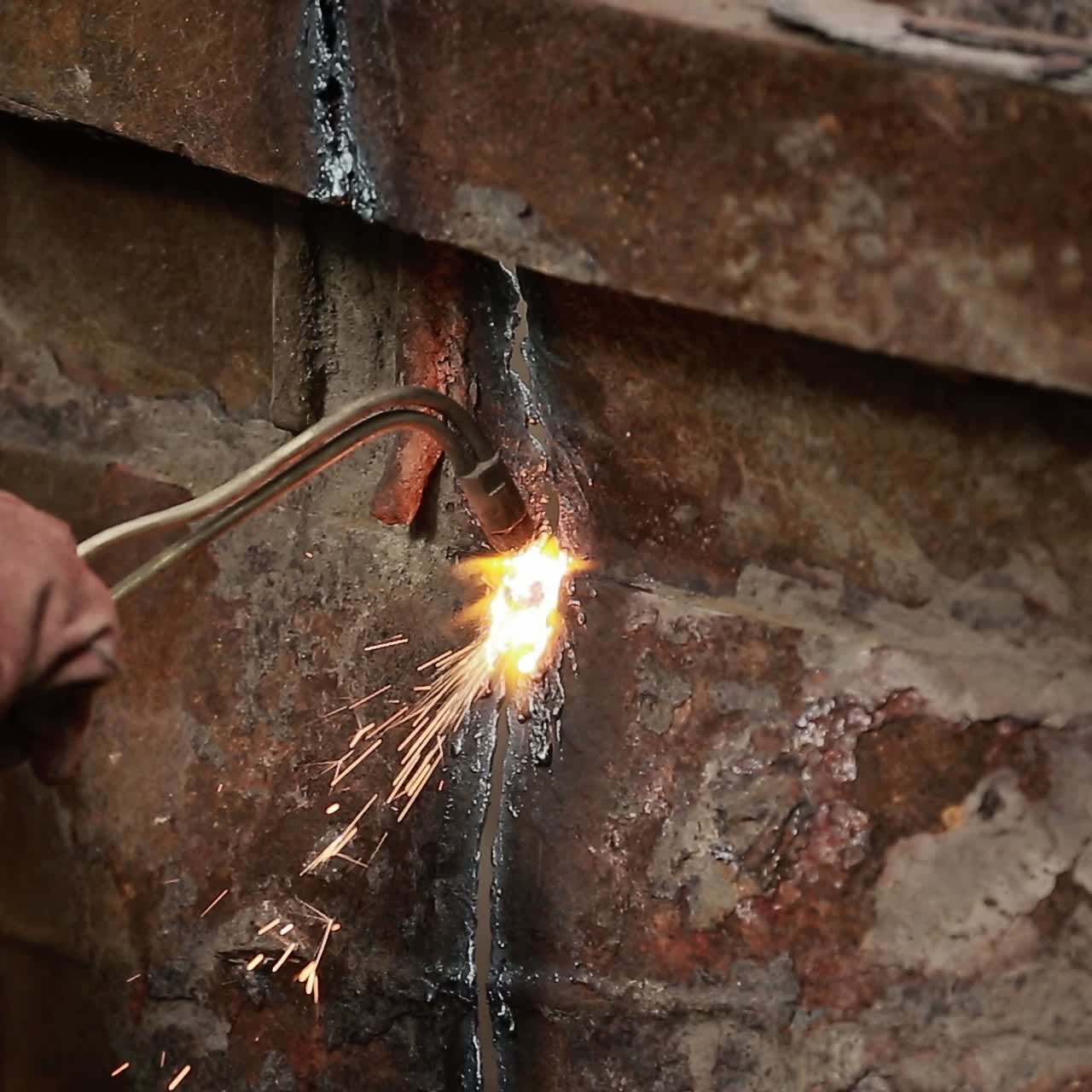 Worker cutting metal