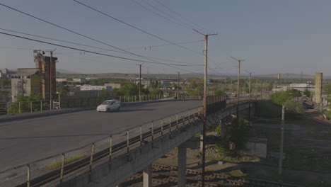 Slow-ascending-shot-of-cars-driving-over-a-bridge