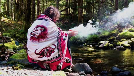 Sangoma---Shaman-woman-at-the-creeks-edge-with-a-burning-bowl,-speaking-with-her-Ancestors