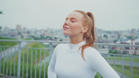 redhead woman exercising in the city