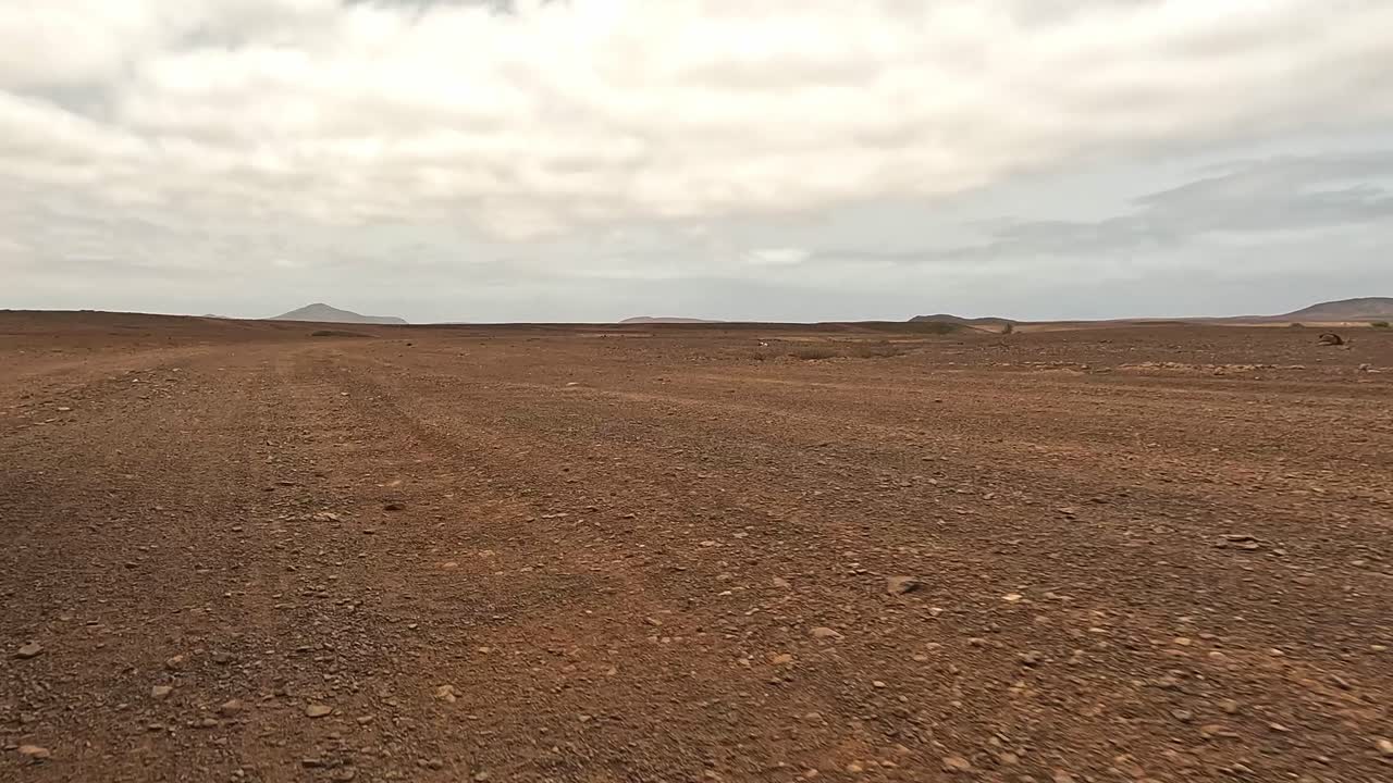 Driving on dry arid desert dirt road of Boa Vista island, Cape Verde. Car point of view