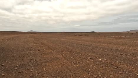driving on dry arid desert dirt road of boa vista island, cape verde. car point of view