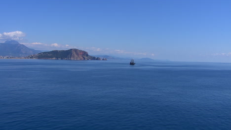 aerial establishing shot of a pirate ship sailing off the coast of turkey