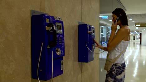 a woman coming to the telephone and calls
