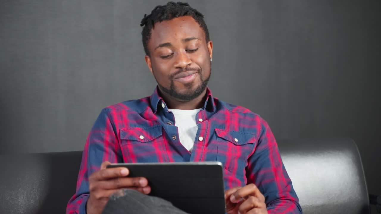 Man using tablet on couch