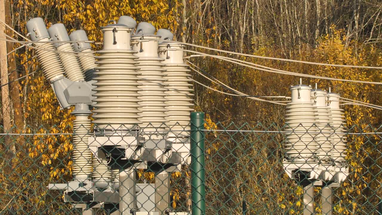 Power lines with sun rays on blue sky