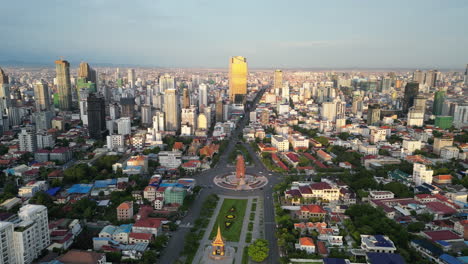 direct aerial showing the central boulevard and independence monument stretching into phnom penh’s modern skyline