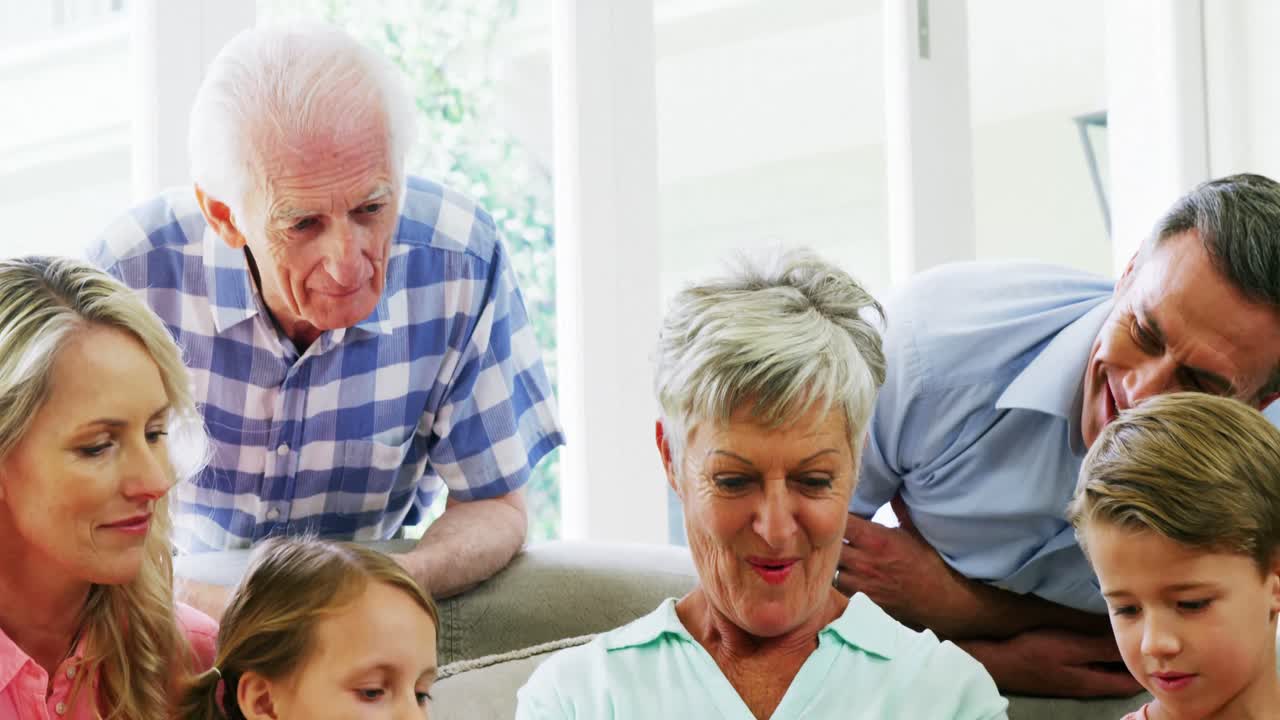 Multi-generation family sitting together in living room