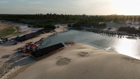 orbit drone shot of hotel resort in lencois maranhenses national park at sunset in maranhao state, northeastern brazil