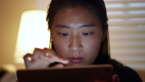 a young woman engrossed in her device, captured in two frames illustrating focus and engagement in a comfortable indoor setting