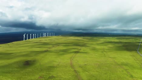 aerial of wind turbine green energy power field on big island, hawaii usa
